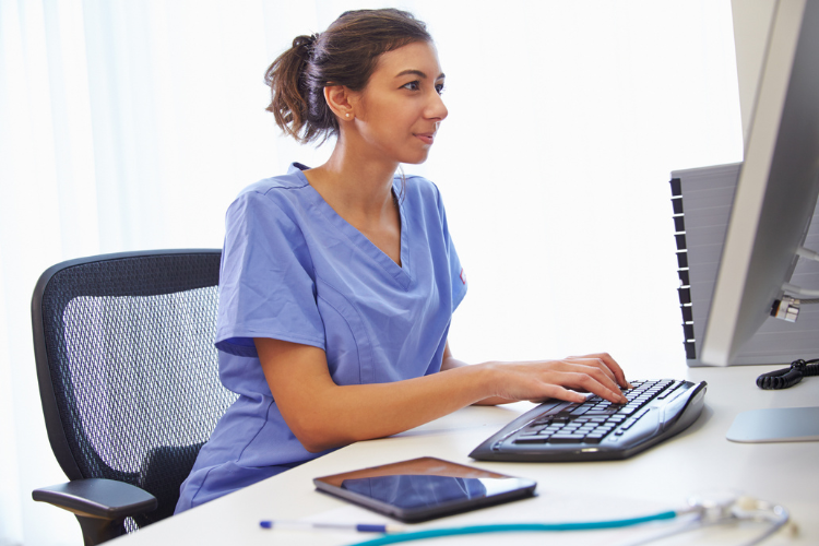 healthcare professional on a computer