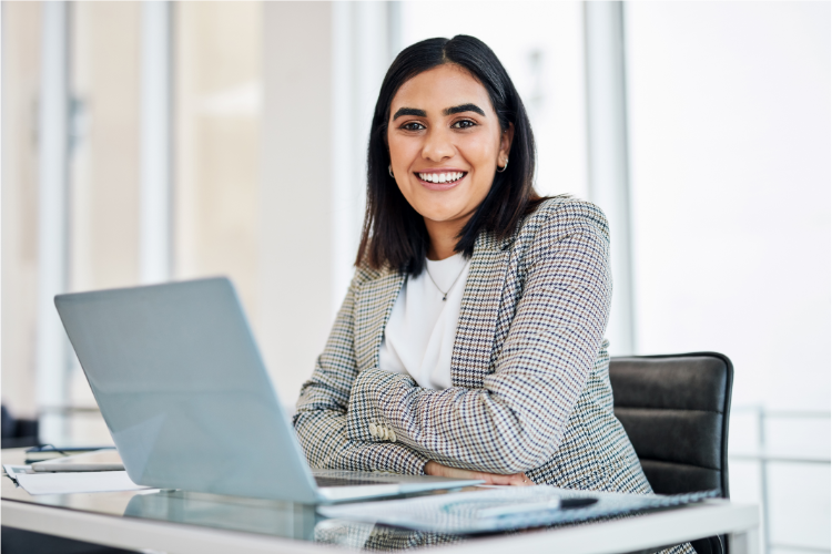 Smiling female professional at a computer