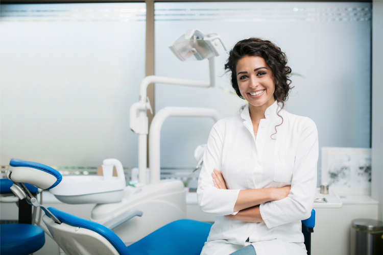 Female dentist smiling after achieving dental continuing education