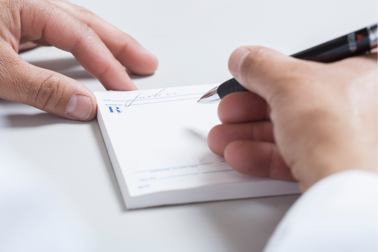 Doctor's hands writing prescription