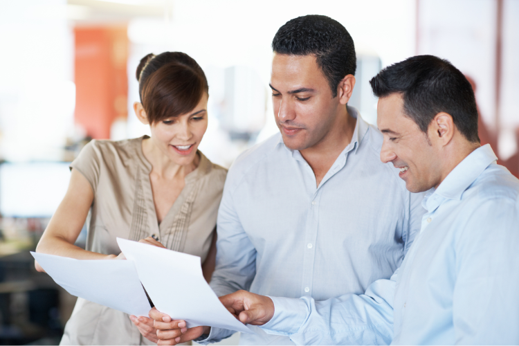 Three business people looking at a document