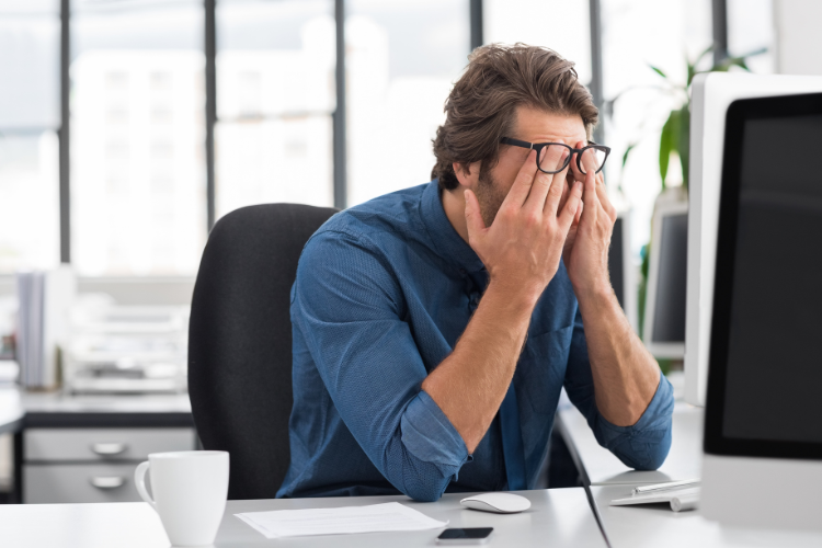 Man frustrated sitting at computer