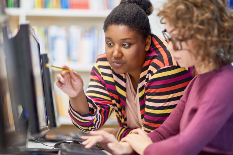 Two women looking at a computer screen