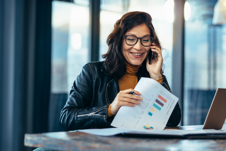 financial person on phone in office smiling