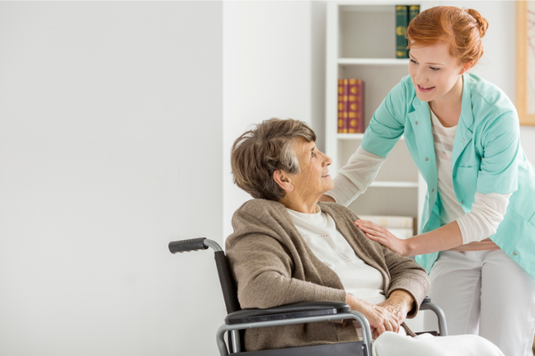 Nurse with older woman in wheelchair